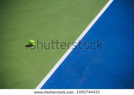 Tennis Ball Rolling Out of Bounds at UC Berkley Royalty-Free Stock Photo #1490744435
