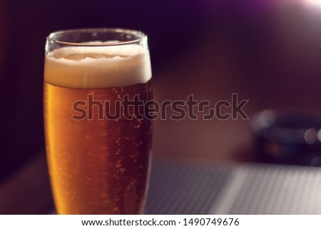 glass of beer close up on wooden table