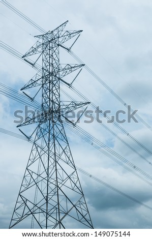 High voltage electricity pylon and the sky with many clouds