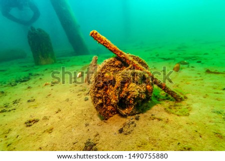 Metal debris under fresh water pier in Lake Superior Royalty-Free Stock Photo #1490755880