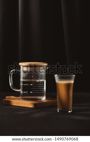 Water bottles and milk coffee glass on dark background. 