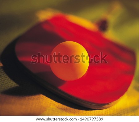 Close up photo of a red skateboard with a ball
