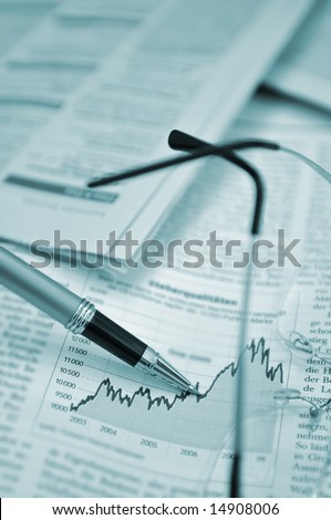 Pen showing diagram on financial report/magazine