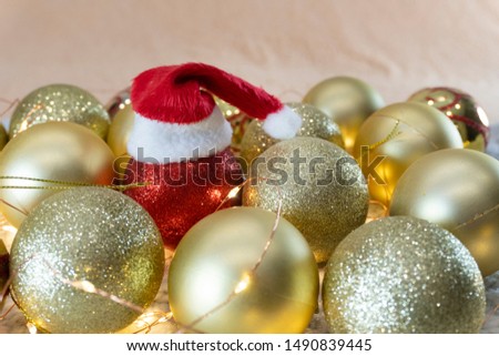 Christmas decorations close-up. Christmas toys in red and gold. Christmas yellow garland on the table.