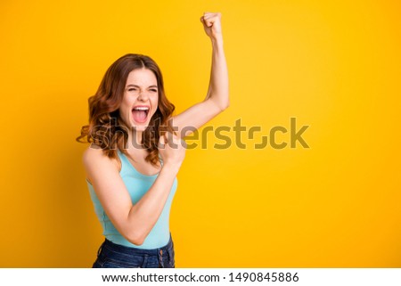 Turned photo of beautiful cheerful trendy pretty rejoicing excited girlfriend wearing turquoise tank-top jeans denim while isolated over yellow vibrant color background