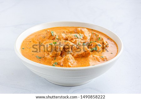 Indian Butter Chicken / Murgh Makhani in a Bowl on WHite Background Close Up Photo. Royalty-Free Stock Photo #1490858222