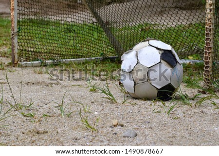 Old football on flooring sand, Concept sport equipment is lacking.