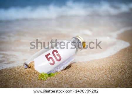 5G written as massage in a bottle washed ashore and layed on the sand