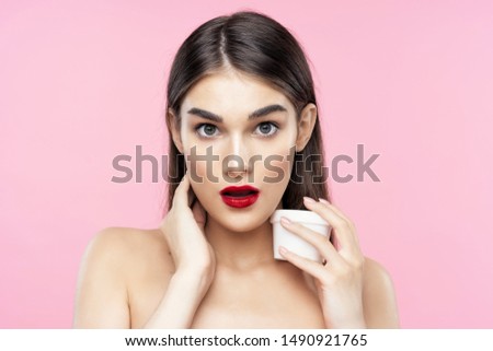 Surprised woman with bright makeup looks at camera cropped view