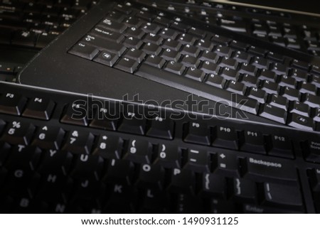 Multiple computer keyboards. Could be used as a background or illustration for technology or computing or communication.  