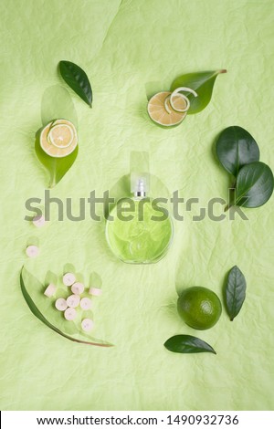  perfume bottle around ingredients  background on green background