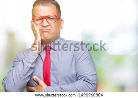 Middle age arab man wearing fashion red glasses over isolated background thinking looking tired and bored with depression problems with crossed arms.