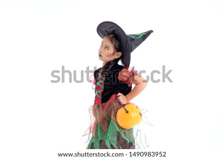 Asian little girl in costume of witch isolated on white background. Happy halloween concept.
