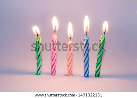 Burning birthday candles on Blue background