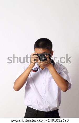 The young Thai student boy on the white background.