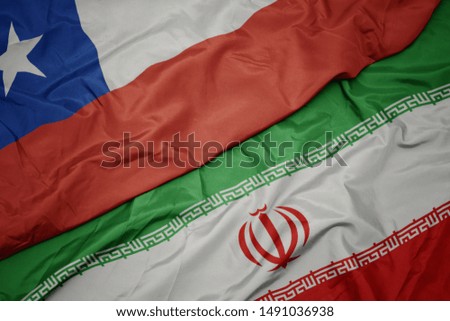 waving colorful flag of iran and national flag of chile. macro