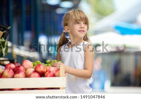 Cute Little Girl Choosing Fruits