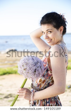 Smiling woman hold hairs back preventing to fall