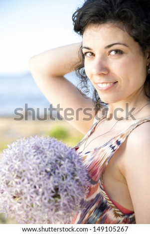 Young woman with dark hairs hold lilac boquet