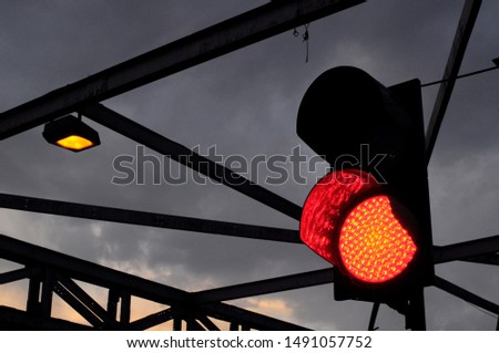 traffic light at the start of a evening in a cloudy day