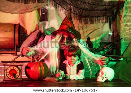 Father and son play Halloween. Scary stories. Happy family celebrate Halloween. Portrait of funny family during Halloween
