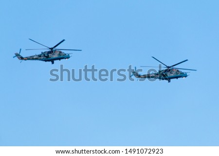 Military helicopters in flight on a blue background