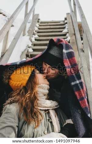The happy couple in love making selfie at the nature park in the cold season. Travel adventure love story