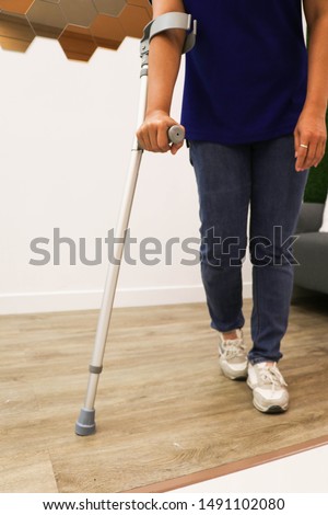 Supporting crutches to help the elderly on the background