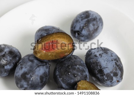 natural fresh plums in a white plate