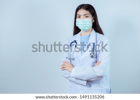 Portrait of young female doctor wearing a mask Shooting in studio. Isolated white background.