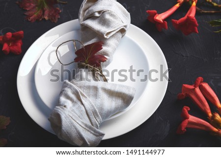 Fall table setting for Thanksgiving day celebration on dark background. Autumn table setting.
