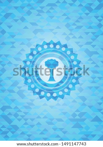 tree icon inside sky blue emblem with mosaic background