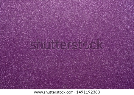 Purple glitters. Abstract shiny background. Design paper texture for decoration and design of Christmas, New Year or other holiday pictures. Beautiful packaging material.