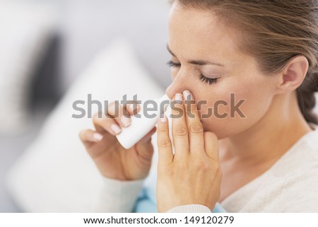 Closeup on pills pack in hand of ill young woman laying on sofa Royalty-Free Stock Photo #149120279