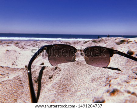 Beach sunglass with sand in the summer