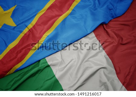 waving colorful flag of italy and national flag of democratic republic of the congo. macro