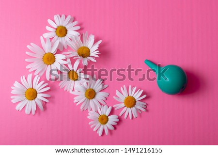 green douche enema bowel washing, rinse mouth, nose top view on a pink background Royalty-Free Stock Photo #1491216155