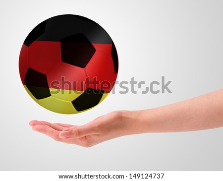 Hands holding a ball with flag of germany