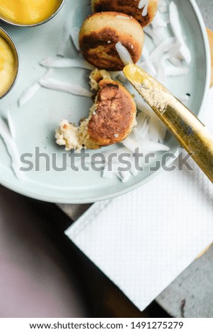 Vegan tofu cheese pancakes on blue plate, gray concrete table. Sun light. Food blog photography concept. Overhead