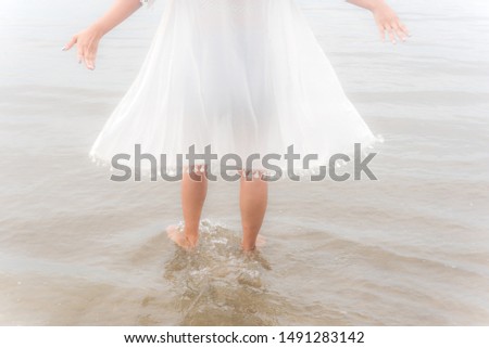 The back of the female leg Walk into the sea On vacation