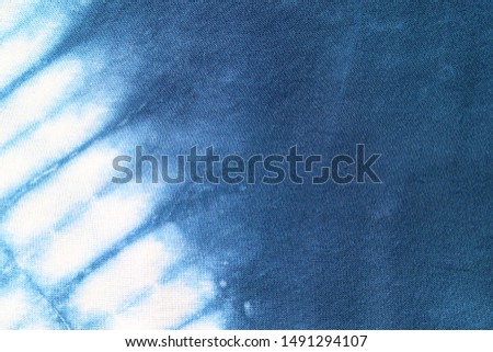 Pattern of natural blue tie dye indigo fabric abstract background texture.
