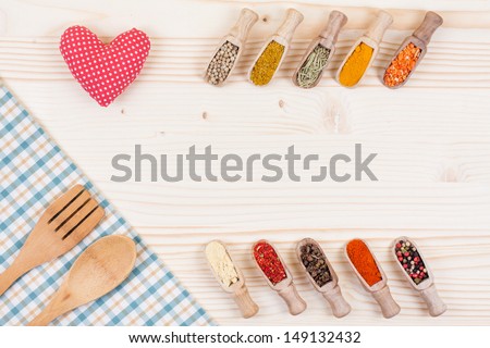 Tablecloth, spices, spoon, fork, heart on wooden background