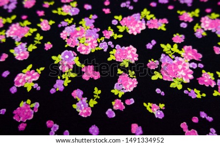 Flower fabric background. Abstract beautiful pink and purple floral fabric texture and pattern. Cotton cloth is black. Vintage flora blossom and leaf wallpaper for summer. Beauty and fashion concept.