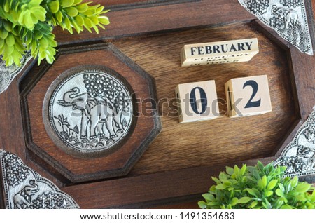 February 2, Date with elephant silver wooden design.