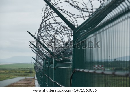 Barbed wire on a fence. Protection and prohibition, prison concept.