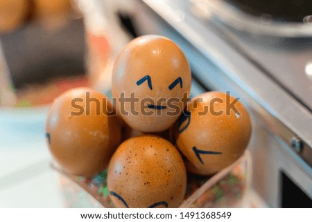 Brown eggs with happy face and friends