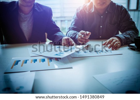 Middle-aged Asian business man Discuss problems and opportunities for business growth. In order to create good profits in the future in the meeting room.