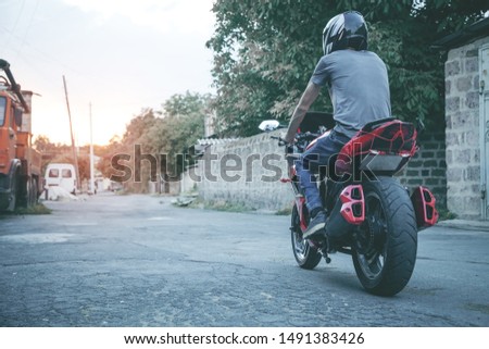 Man biker on his motorcycle in outdoors.