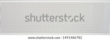 White metal perforated sheet with circular holes for industrial or texture and background Royalty-Free Stock Photo #1491486782