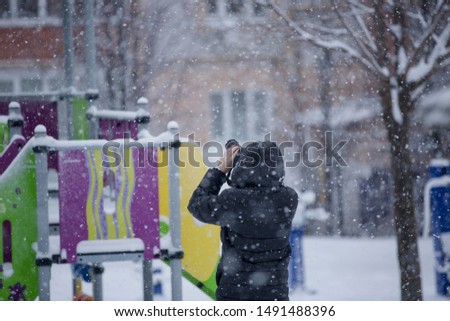 Photographer takes pictures of snowfall in winter.